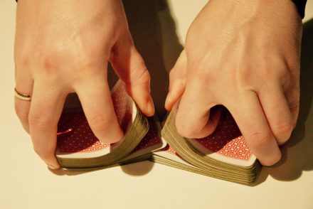 person shuffling playing cards